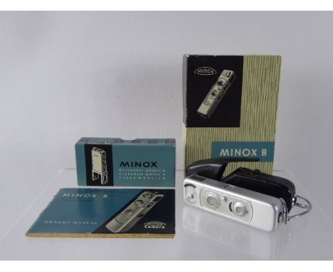 A Minox B Ultra Miniature Camera, with built-in coupled exposure meter, black and white film and flash, owner's manual in the