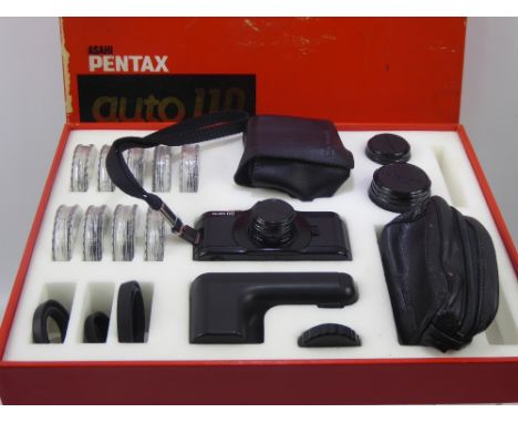 An Asahi Pentax Auto 110 SLR System Camera, in the original box with accessories including 25.5mm filter, 30.5 Skylight, 30.5