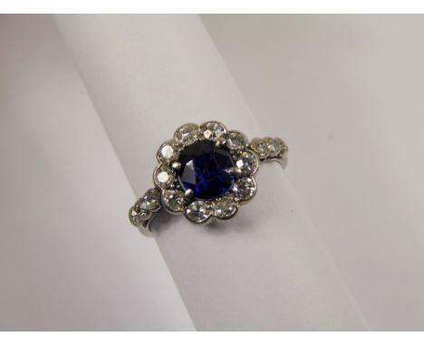 A Lady's Antique Platinum Royal Blue Sapphire and Diamond Ring, the deep royal blue cushion set sapphire of 6 x 4.5mm surroun