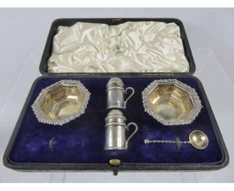 A Boxed Set of Silver Salt and Pepper, Birmingham hallmark, spoon missing, mm STS, together with a silver plated inkwell stan