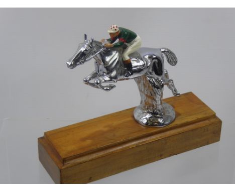 A Chrome Figure of a Race Horse, and enamel jockey on a wooden plinth, approx 17 cms high x 20 cms long.