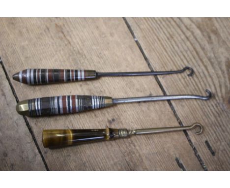 Two Trench Art metal button hooks, with bands of various metals and a Tiger's eye handled button hook (3) 