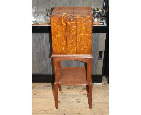 A Victorian Oak Specimen Cabinet, Late 19th Century.  With a pair of doors, opening to reveal three drawers containing button