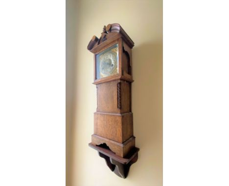 A Miniature Longcase Clock. On bracket. 