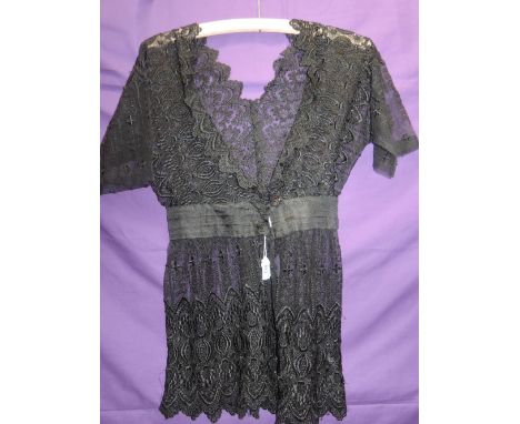 An early 20th century lace bodice having low neckline, hook and eye fastening and sash to waist,incredibly good condition for