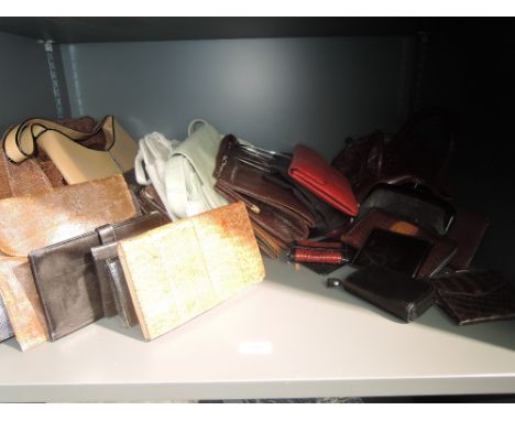 A large selection of vintage and modern handbags and purses, mixed styles and eras. Some wear to a few.