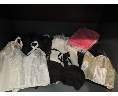 A collection of vintage lingerie including a set of nylon pyjamas, three bras, and five slips, all in good condition, mostly 