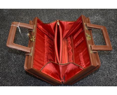 Vintage tan coloured overnight/ vanity case having internal pockets and compartments. Good condition.
