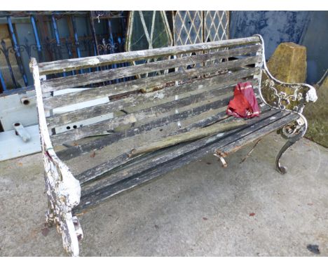 A VINTAGE GARDEN BENCH WITH CAST IRON LION MASKS ENDS