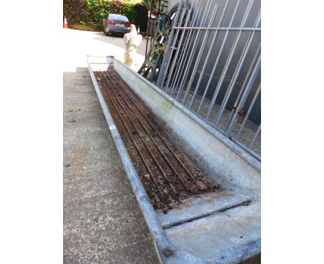 A LARGE LONG GALVANIZED TROUGH