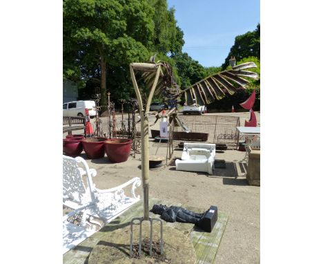 A METAL BIRD ON A GARDEN FORK, AND A METAL SCULPTURE