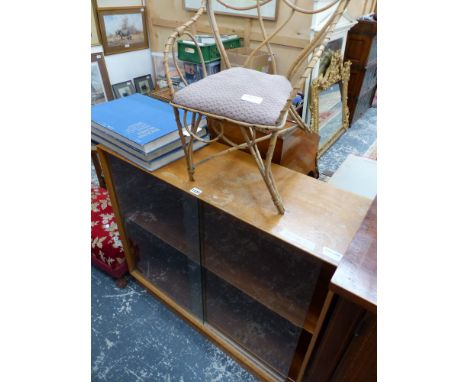 A TEAK SHELF UNIT WITH SLIDING GLASS DOORS.   W 97 x D 31 x H 82cms. TOGETHER WITH A CANE HOOP BACKED CHILDS CHAIR