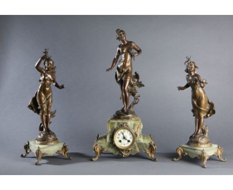 Green onyx mantel clock surmounted by a r‚gule (?) sculpture of a draped woman holding flowers, titled in a riveted cartouche