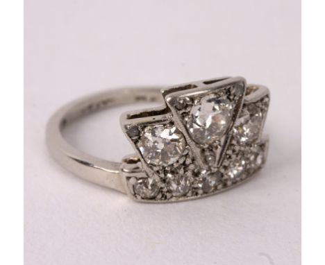 An Art Deco diamond ring of stylised coronet design, the principal stone 0.2ct, set in platinum, size H 