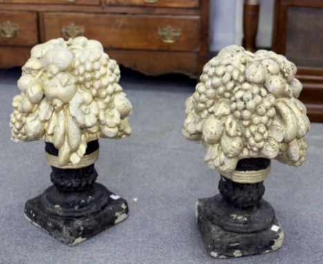 Two painted reconstituted stone gate post finials, vases of fruit, 53.5cm high