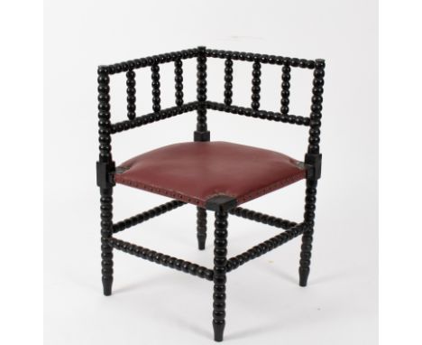 A William Morris Sussex style ebonised chair, with bobbin turned supports