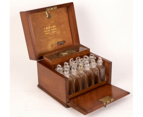 A 19th Century mahogany apothecary box by S Maw &amp; Son, London, fitted with scales, weights, files, jars and fourteen bott