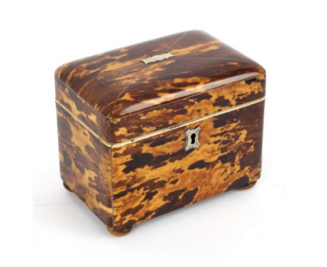 A Regency tortoiseshell tea caddy of rectangular form on bun feet, 12.5cm wide