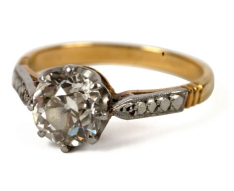 A solitaire diamond ring, the cushion shaped stone of approximately 1.4ct, set in white metal to a yellow metal shank, size M