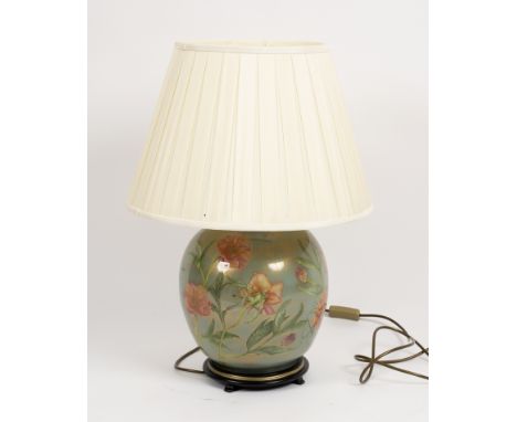 A large floral pottery table lamp with shade