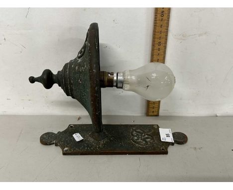 A brass wall light bearing GR sypher