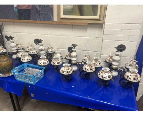 Set of four 20th Century continental iron and ceramic five branch ceiling light fittings with floral decoration