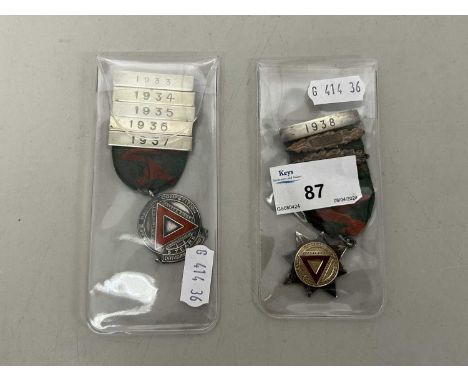 Two National Safety First Association driving medals with various clasps