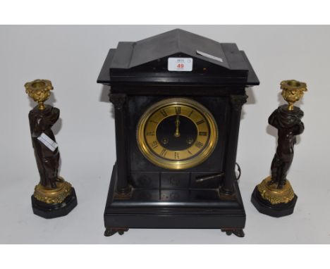 SLATE MANTEL CLOCK WITH GOLD DIAL AND TWO REEDED COLUMNS, TOGETHER WITH A PAIR OF CANDLESTICKS MODELLED AS STANDING CHERUBS W