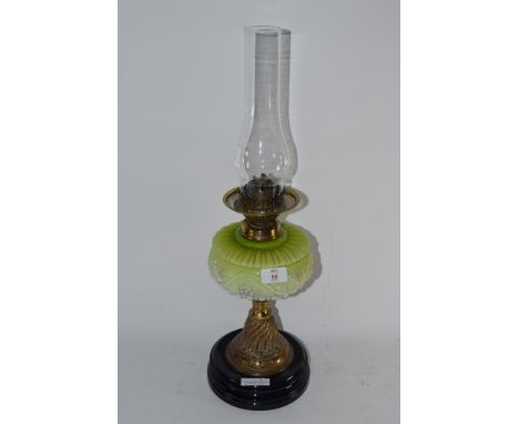 OIL LAMP ON CIRCULAR BLACK BASE WITH GLASS SHADE DECORATED IN RELIEF WITH A FLORAL PATTERN WITH GLASS CHIMNEY