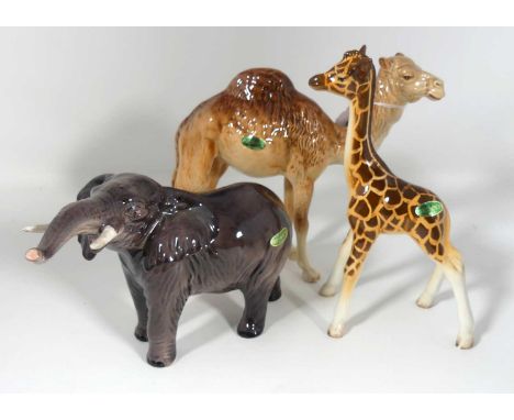A Beswick pottery figure of a camel, modelled standing, height 17.5cm, together with an elephant and a giraffe (3)Free of dam