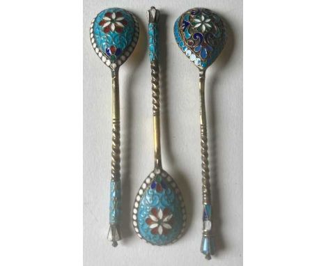 Three late 19th century Russian silver-gilt and cloisonne enamel spoons, being a pair and one single, the reverse of the gilt