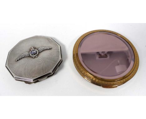 An engine turned white metal powder compact, the cover embossed with the RAF wings, together with a gilt metal lady's powder 