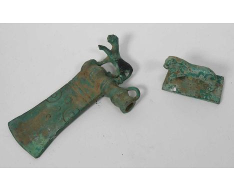 A reproduction zoomorphic iron age axe head; together with a metal lion (2)