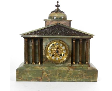 A late 19th century green onyx mantel clock of architectural form having a dome top surmounted by a brass finial with allegor