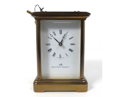 A Matthew Norman lacquered brass carriage clock having visible platform escapement, single barrel going movement, back plate 