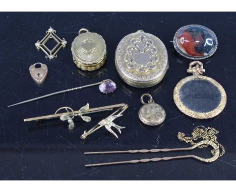 An engine turned and engraved pinchbeck oval picture locket, 2.2cm; together with a larger example; a 9ct gold seed pearl bar