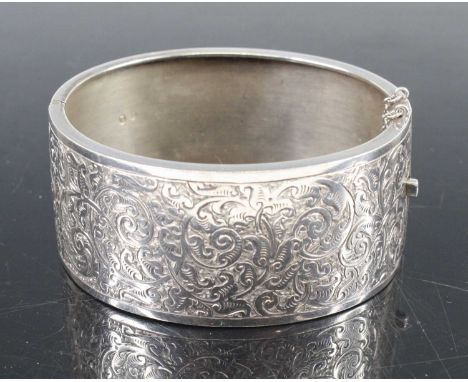 A Victorian style silver engraved hinged bangle, w.2.9cm, dia.6.4cm, 26g