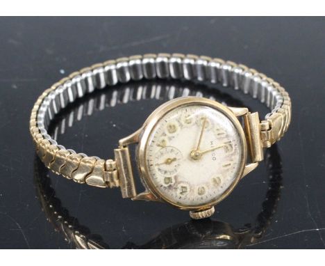 A lady's Hirco 9ct gold cased manual wind wristwatch, with Dennison case, on expanding gilt metal bracelet