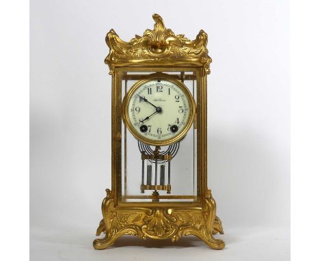An early 20th century American brass mounted four glass mantel clock, the enamel dial signed Seth Thomas, showing Arabic mark