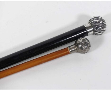 A military officer's swagger stick, the white metal pommel bearing the crest of the Lancaster regiment, length 67cm, together