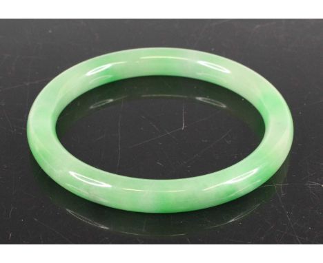 A Chinese green jade bangle, dia. 8cm, 49.6g