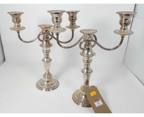 A pair of silver plated three-branched table candelabra, height 33cm