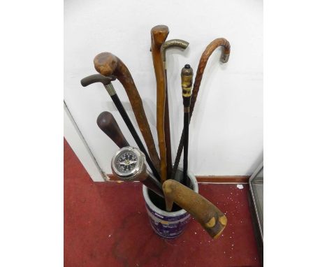 Walking sticks to include horn handled example, having a white metal collar and a compass handled example, together with a bl