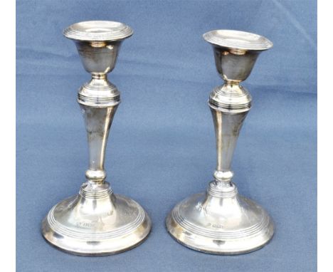 A PAIR OF EDWARDIAN SILVER CANDLESTICKS standing 14.5cm tall, hallmarked Birmingham 1909.  Sponsors mark William Hutton &amp;