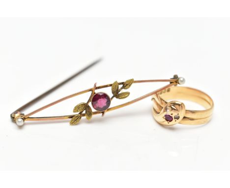 AN EDWARDIAN GARNET AND SEED PEARL BROOCH AND AN OUROBOROS RING, the brooch of an openwork design, foliate detail set with a 