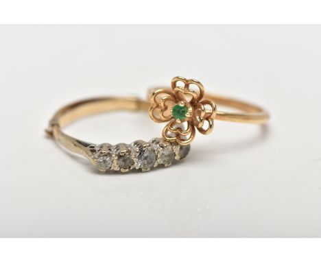 TWO GEM SET RINGS, the first a designed as a small openwork flower centering on a small claw set emerald, to a polished thin 