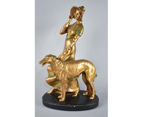 An Art Deco Chalk Figure of Maiden with Afghan Hound, Gilt and Green Enamel and Ebonized Oval Base, 37cms High 