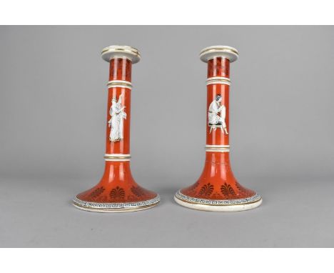 A Pair of Late 19th Century of Prattware Candlesticks Decorated with Classical Figures on Coral Red Ground, 21cm high (Condit