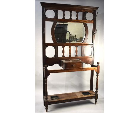 An Edwardian Mahogany Hall Stand with Centre Glove Drawer , Mirror with Bevelled Glass , Six Coat Hooks and Two Metal Drip Tr