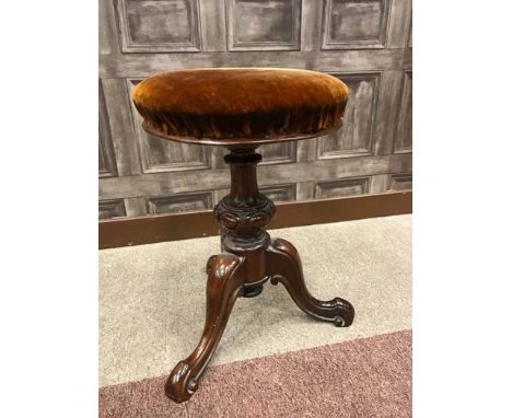 VICTORIAN WALNUT CIRCULAR PIANO STOOLon a vase shaped pillar on tripod legs, 34cm diameter